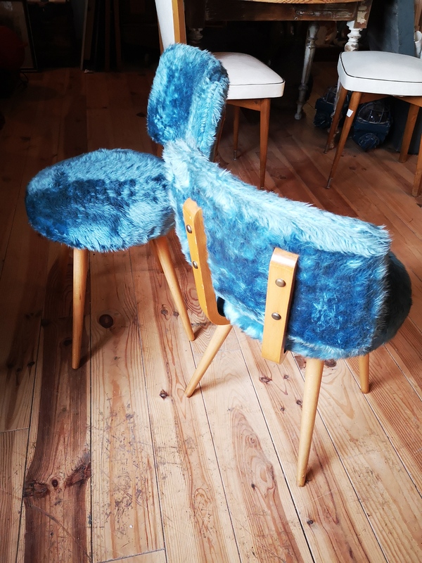 Wooden chair and blue toupee
