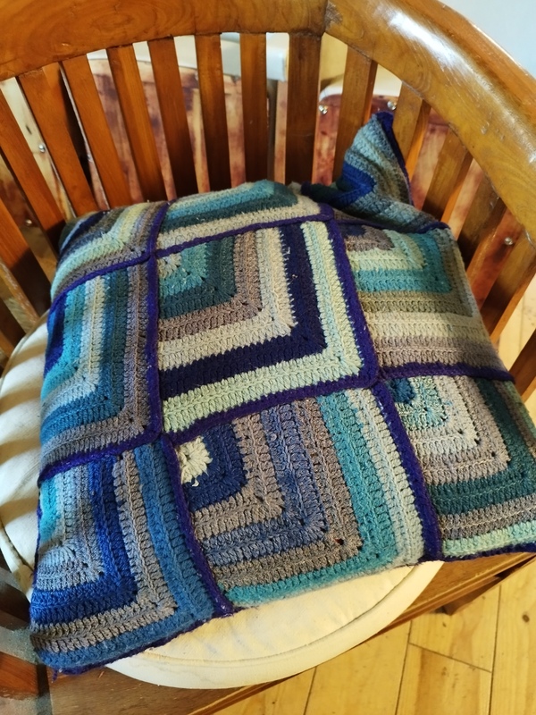 Vintage feather and crochet cushion