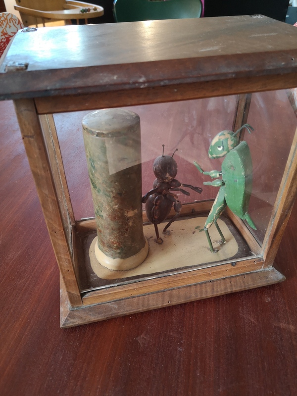 Old wooden toy the cicada and the ant