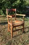 Antique armchair made of wood and straw