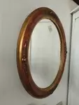 Golden oval mirror