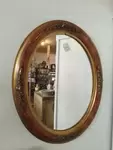 Golden oval mirror