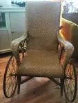 Rattan rest chair with wrought iron wheels