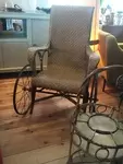 Rattan rest chair with wrought iron wheels