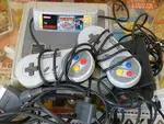 Super Nintendo + two controllers + Mario all stars