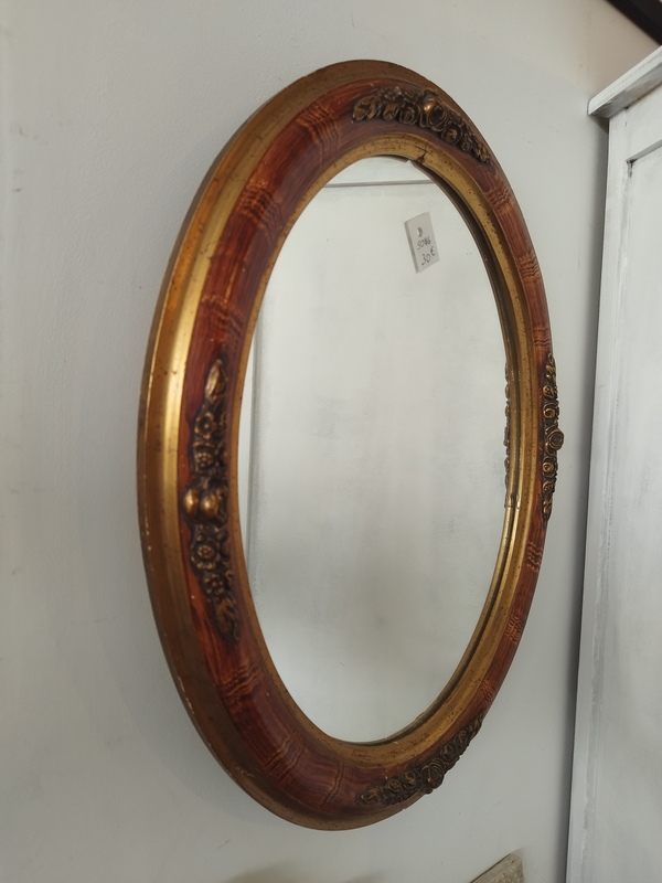 Golden oval mirror