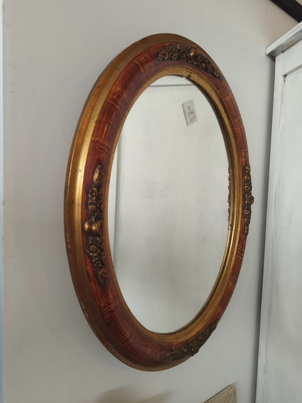Golden oval mirror