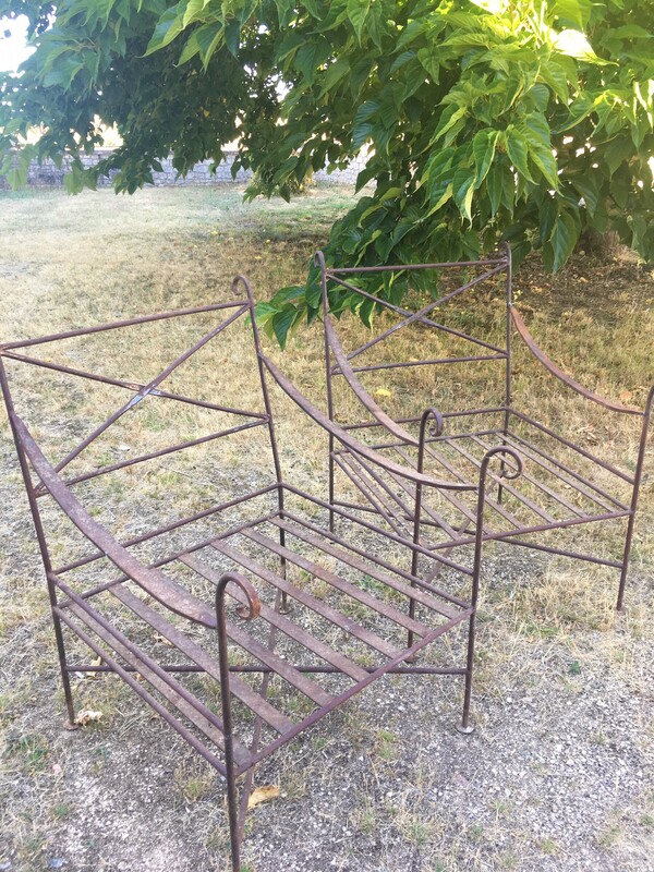 Pair of wrought iron garden armchairs